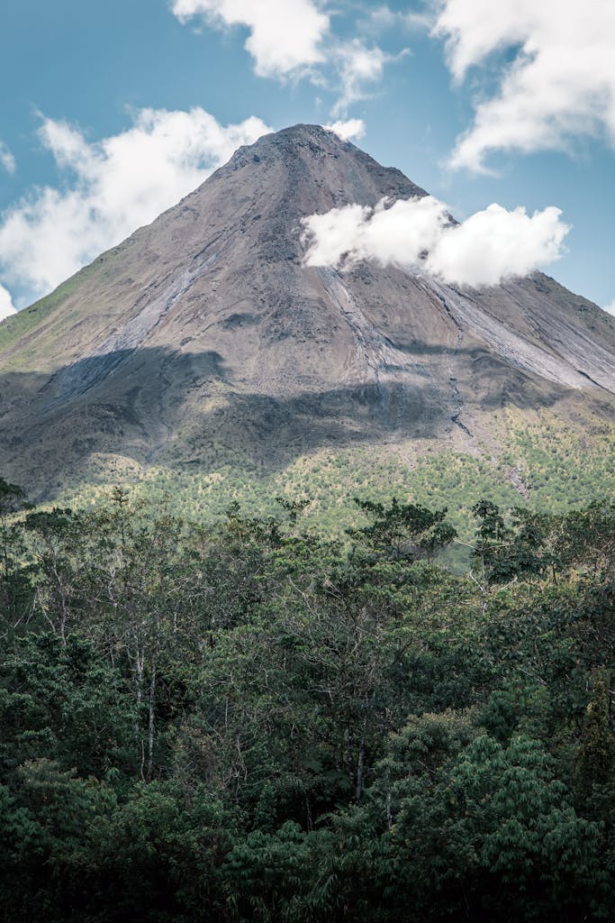 Explore the breathtaking landscape of Arenal Volcano surrounded by lush forest in Costa Rica.