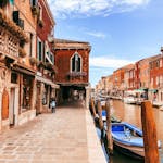 Explore the scenic canals of Venice with vibrant buildings and rich history.