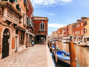 Explore the scenic canals of Venice with vibrant buildings and rich history.
