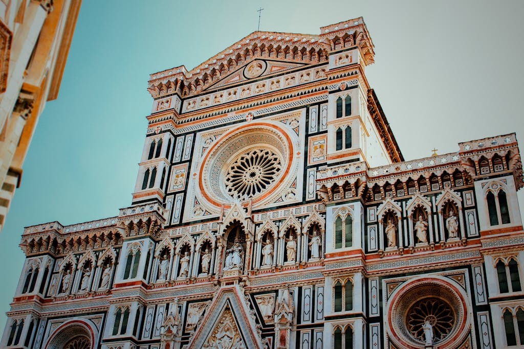 Intricate details of the Florence Cathedral facade showcasing Gothic architecture in bright daylight.