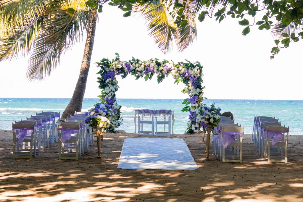 Beautiful outdoor beach wedding setup with floral arch in Puerto Plata.
