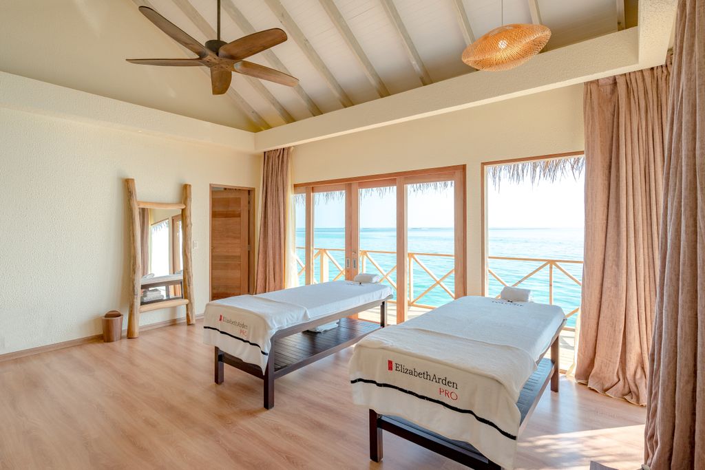 Tranquil spa room with massage tables overlooking the stunning Maldivian ocean view.